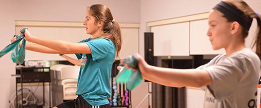 PT helping woman